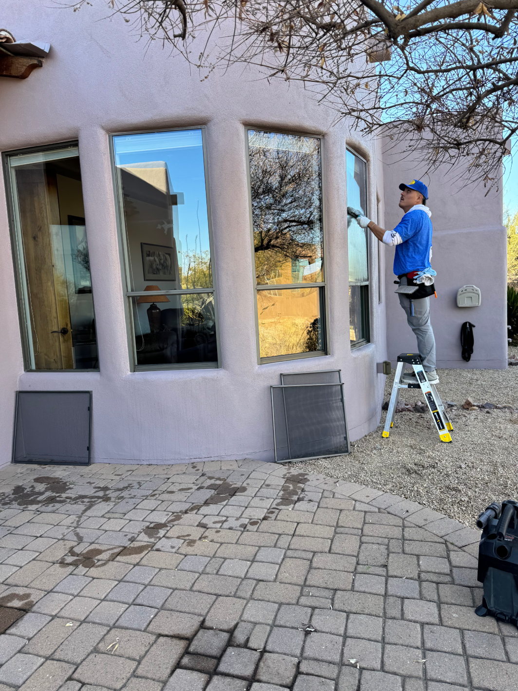 A serene pool and patio area overlooking a scenic mountain view, perfect for relaxation and outdoor enjoyment (1) Elko Clean window cleaner with squeegee outside home with tall breakfast nook windows